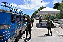 Police officers check a passing jeepney at a checkpoint in Bohol Bohol COVID-19 GCQ checkpoint 1.jpg