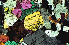 Bronzitite, thin section of a rock made of olivine and pyroxene, mostly bronzite. Photomicrograph, viewed with polarized light. Bronzitite.jpg