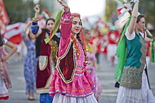 Canadians walk in a parade wearing festive colors: 2017