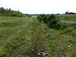 The site of the southern platform with the old passenger ramp. Commondyke railway station site and ramp, Near Auchinleck, East Ayrshire, Scotland.jpg