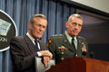Secretary of Defense Donald H. Rumsfeld (left) and Commander, Central Command Gen. Tommy Franks, U.S. Army, listen to a question at the close of a Pentagon press conference on March 5, 2003.