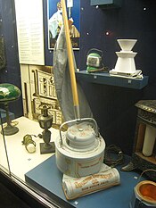 An early electric vacuum cleaner by the Electric Suction Sweeper Company, circa 1908, predecessor of the Hoover vacuum cleaner (1922). Early electric vacuum cleaner, circa 1908.jpg