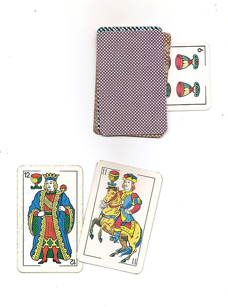 A 6 of cups is tucked under the deck in a game of Brisca, to show that cups is the trump suit