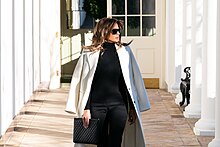 Trump wearing a coat over her shoulders First Lady Melania Trump on the Colonnade (40065160653).jpg