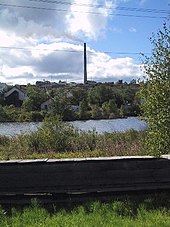 Flin Flon (in Manitoba, Canada) is built on rock, making excavation costly. The utilidor in the foreground carries municipal sewer and water services and protects piping from freezing in the winter. FlinFlon Stack.jpg