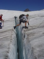 Crossing a crevasse on the Easton Glacier, Mount Baker, in the North Cascades, United States.