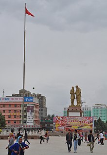 Kurban Tulum with Mao Zedong, Hotan, China.jpg