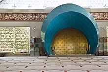 The interior of a modern mosque. The camera is focused on its mihrab.