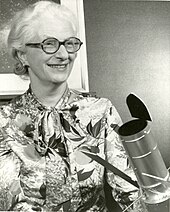 Nancy Grace Roman with a model of the Large Space Telescope that was eventually developed as the Hubble Space Telescope. While listed as a 1966 photo, this design was not the standard until the mid-1970s. Nancy Grace Roman with Space Telescope Model in 1966 (27154772837).jpg