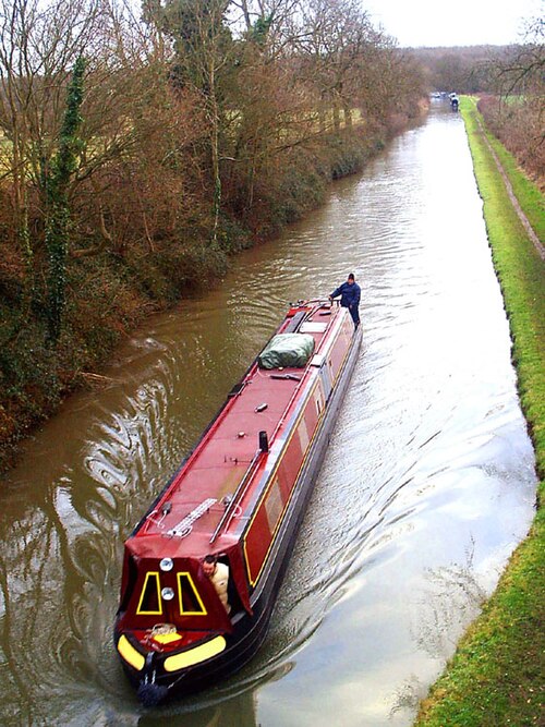 A canal boat on the canal near Brinklow on the long stretch between Coventry and Rugby.