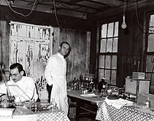 PHS scientific investigators working in their makeshift laboratory during the 1937-1938 industrial hygiene study of mercury exposure and its health effects in the hatmaking industry. PHS scientists at hatmaking study 1930s.jpg