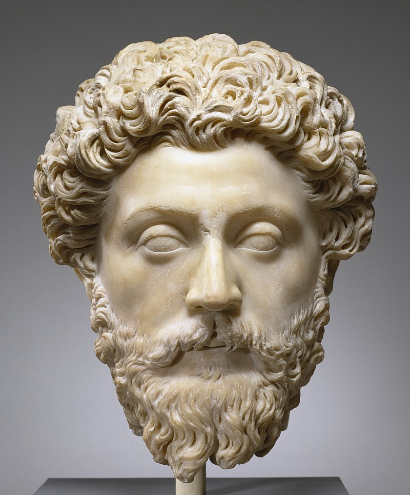 Marble bust of Marcus Aurelius. This masterful portrait captures the pensive temperament of the philosopher-emperor and author of the celebrated 'Meditations', reflections on life and the ways of the gods. The smooth, softly modeled carving of the flesh contrasts markedly with the mass of thick, curling hair. The drooping eyelids and detached gaze suggest his contemplative nature.