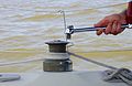 Taking handle out of winch on a sailboat.jpg