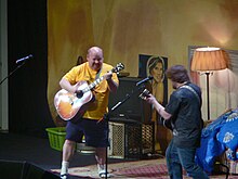 Kyle Gass performing with Tenacious D while wearing socks and sandals Tenacious D in concert 3.jpg