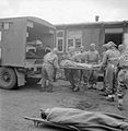 Royal Army Medical Corps, wearing protective clothing, evacuating an inmate suffering from typhus from Bergen-Belsen concentration camp No 1. By 2 May 1945, 6,500 of the sick had been evacuated to hospital.