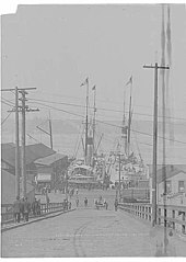 U.S.A.T. Rosecrans and Lawton docked at the foot of University St. in Seattle, preparing to transport U.S. troops to China, 1900