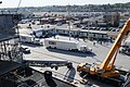 US Navy 111108-N-RG587-105 ESPN trucks arrive with broadcasting equipment as workers construct a basketball arena aboard the Nimitz-class aircraft.jpg
