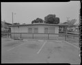 View of east elevation of Building No. 24. Parking Area No. 37 in foreground. Looking west-northwest - Easter Hill Village, Building No. 24, South side of South Twenty-sixth Street, HABS CA-2783-Q-3.tif