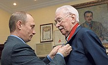 Mikhalkov receiving the Order for Service to the Fatherland 2nd Class from President of Russia Vladimir Putin on 13 March 2003.