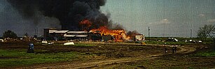 Surrender of four Branch Davidians. Thibodeau is one of the three figures closest to the camera on the road. Waco Siege - Surrender of four Branch Davidians.jpg