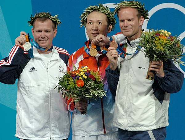 Jia Zhanbo (center) poses with Michael Anti (left) and Christian Planer (right) at the men's three position rifle award ceremony on 22 August 2004.