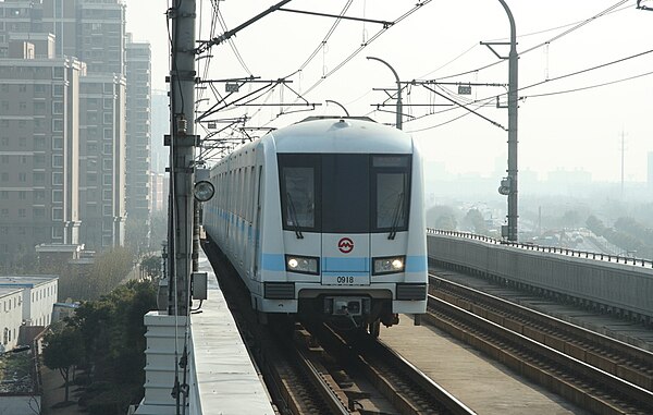 An AC09 train enters Songjiang University Town station.