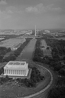 View of the 1963 March on Washington for Jobs and Freedom, with the temporary buildings still in place. The Main Navy and Munitions Buildings are to the left, the Bureau of Supplies and Accounts buildings are to the right, and the Bureau of Ships buildings are at the far end of the Reflecting Pool. Aerial view of marchers, from the Lincoln Monument to the Washington Monument.jpg