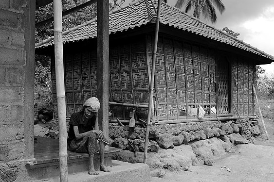 An elderly Balinese woman at a rare traditional house in a poor remote village in East Bali