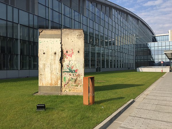 The Fall of the Berlin Wall in 1989 marked a turning point in NATO's role in Europe, and this section of the wall is now displayed outside NATO headqu