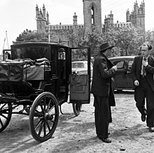 Patrick Kavanagh and Anthony Cronin at the church in Monkstown with the carriage in which they had been proceeding about Dublin in the footsteps of Leopold Bloom, the protagonist in Ulysses, 50 years after Bloom traversed the city in James Joyce's novel.