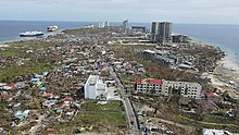 Damage in Punta Engano, Lapu Lapu City. Visible damages to concrete structures, beached ships and downed electric lines. Budotsmedia-odeetteph-damage-puntaengano-20211220.jpg