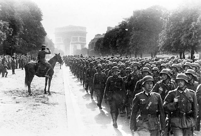 German soldiers march near the Arc de Triomphe in Paris, 14 June 1940.