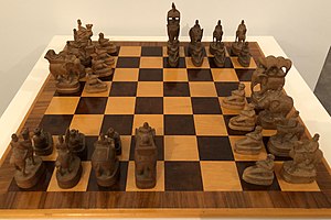 The direction of the chess pieces indicates to which player they belong.