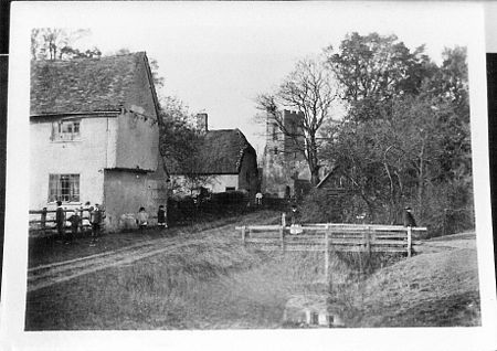 A photograph of Church Walk, Wilden, in about 1900, showing Village Farm, the Post Office (later known as Tudor Cottage), and St Nicholas Church Church Walk Wilden Bedfordshire UK Circa 1900.JPG