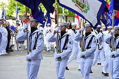 Members of the Navy Ceremonial Guard parade the fifty state flags before a wreath-laying ceremony at the Navy Memorial in Washington D.C.