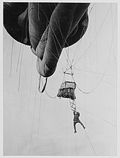 US Navy man disembarking from a kite balloon