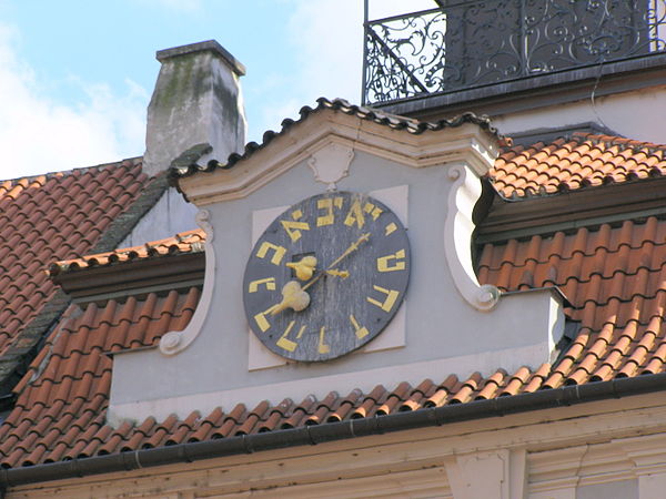 The lower clock on the Jewish Town Hall building in Prague, with Hebrew numerals in counterclockwise order.