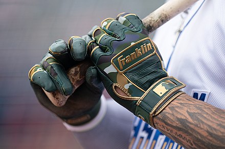 Kyle Isbel of the Omaha Storm Chasers grips a bat using gloves during a 2021 game