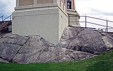 Image depicts Anorthosite at the base of a structure; a type of plutonic rock Large layered anorthosite inclusion (Precambrian) in Beaver River Diabase (Beaver Bay Complex, Mesoproterozoic, 1096 Ma) (Split Rock Lighthouse, Minnesota, USA) 2.jpg