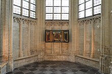 Triptych on the interior northwest stone wall of the apse chapel of Saint Peter's Church in Leuven, Belgium, from 2012.