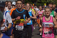 Charity-supporting non-elite participants in the race running along Westferry Road on the Isle of Dogs London Marathon 2014 runners.jpg