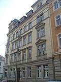 Apartment house in a corner and closed development