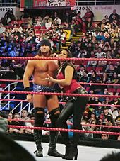 Lea along her on-screen brother Paul Burchill during a WWE Raw event in 2008 Paul and Katie Lea Burchill.jpg