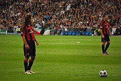 Pirlo (left), with AC Milan, preparing to take a free kick against Real Madrid in the 2010–11 UEFA Champions League