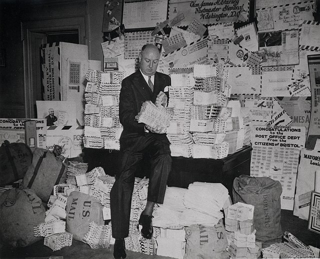 Farley sits on a pile of air mail letters in 1938.
