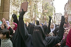 Protesters using their hands for the R4bia sign in Cairo - 14-Feb-2014.jpg