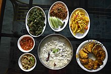 Dahi pakhala ( yogurt pakhala) with assorted side-dishes.