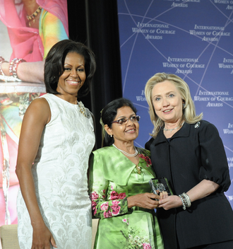 Aneesa Ahmed received the International Women of Courage Award from U.S. Secretary of State Hillary Clinton and First Lady Michelle Obama in 2012 Secretary Clinton and First Lady Obama With 2012 IWOC Award Winner Aneesa Ahmed of Maldives.png