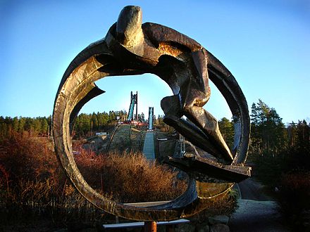 Ski jump sculpture, Lugnet. Hills in the background.