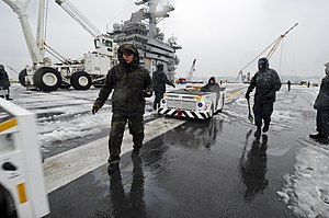 US Navy 120120-N-HN953-014 Sailors aboard the aircraft carrier USS Nimitz (CVN 68) remove snow from the ship's flight deck.jpg